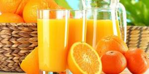 Orange juice in a carafe and glasses, citrus fruits