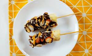 Chocolate covered bananas with almonds