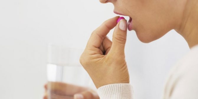 Girl drinking a pill