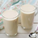 two glasses of fermented baked milk and teaspoons