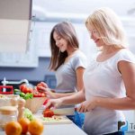 Two girls prepare diet food for themselves