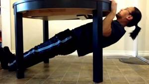 Horizontal pull-ups on a table.