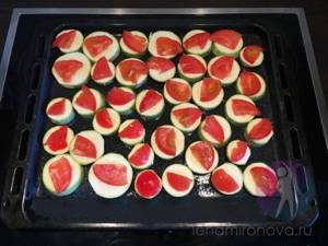 zucchini with tomatoes on a baking sheet