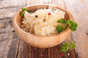 sauerkraut with peppercorns and parsley sprigs in a bowl