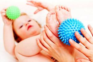 Massaging a child&#39;s feet with a massage ball