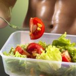 A man eats a vegetable salad with tomatoes