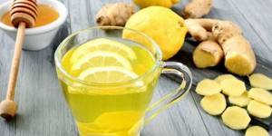 Drink with honey, lemon and ginger in a cup
