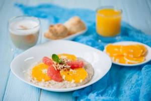 Oatmeal with milk and citrus fruits photo