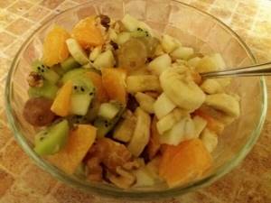 Mixing fruits in a salad bowl