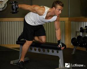 An athlete performs dumbbell back extensions