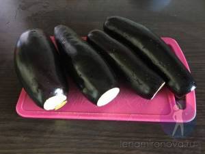 fresh eggplants on a cutting board