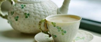 Green tea with milk in a cup and teapot