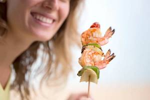 Woman eating shrimp