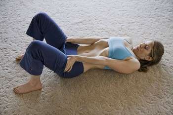Woman lying on the carpet with her stomach pulled in